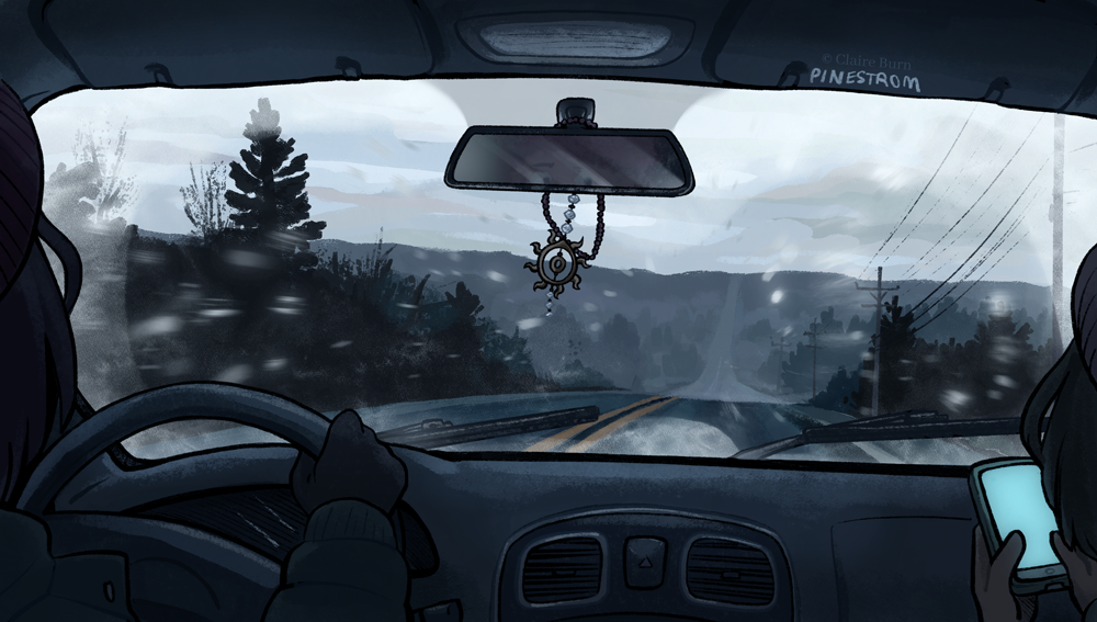 View through a car winshield of a highway in the mountains. It's lightly snowing, and the winshield is frosty.