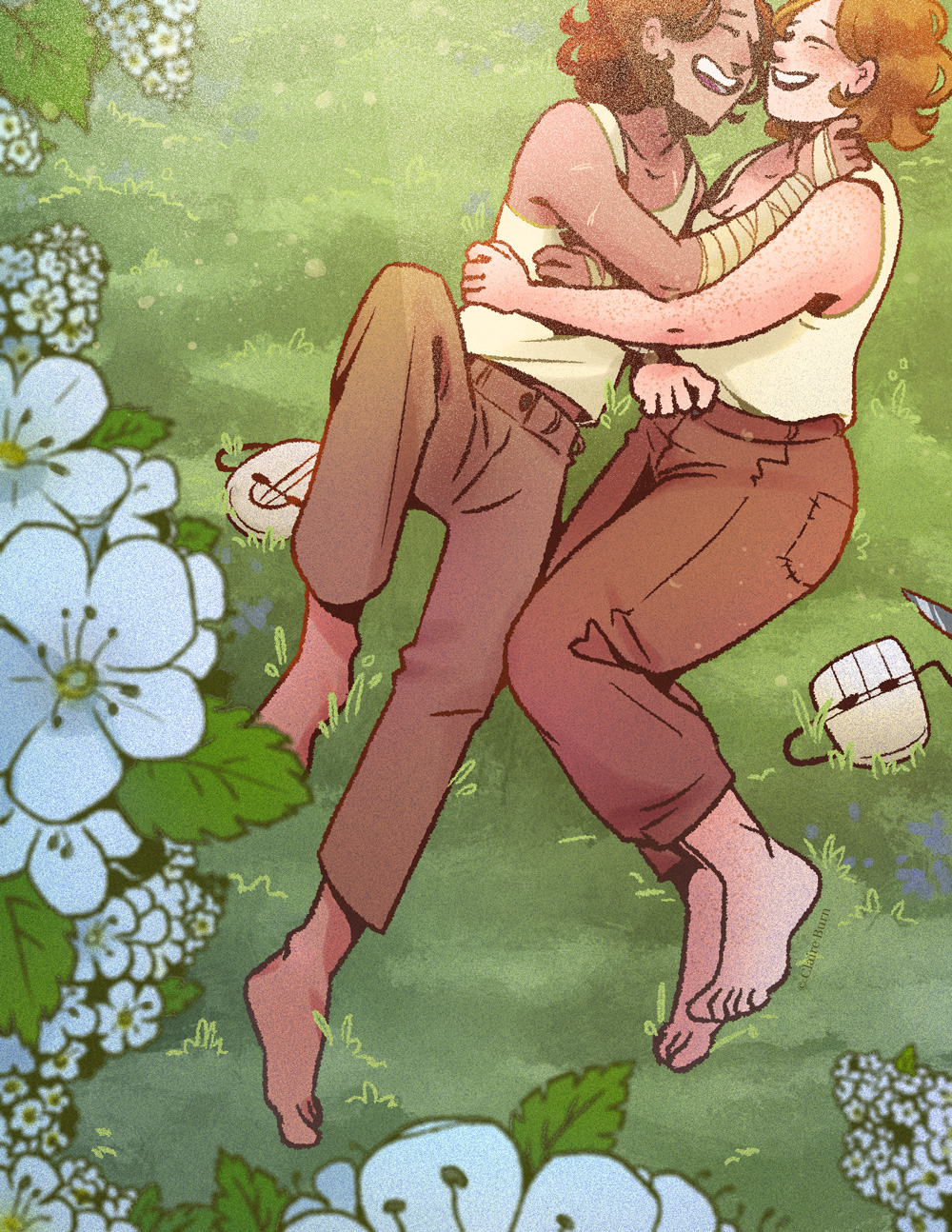 A girl and a boy laying in the grass, embracing and laughing. A blooming hawthorn tree is in the foreground.