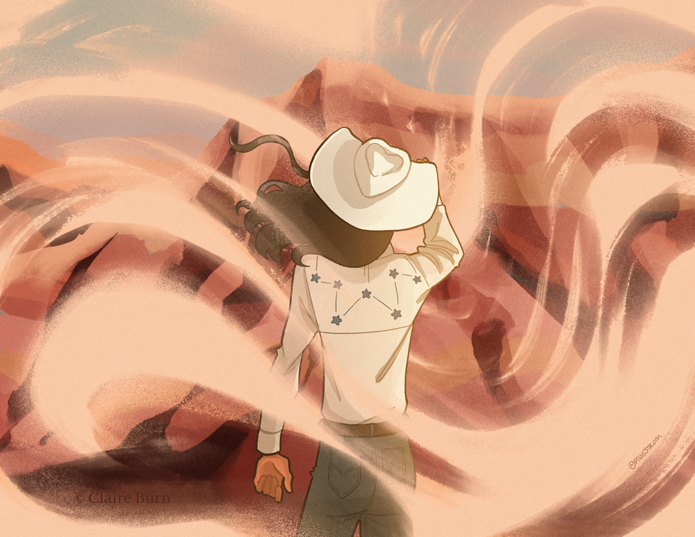 A cowboy stands in the Painted Desert as sand blows around him.