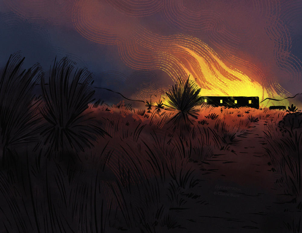 A view across a field of Arizona shrubland, looking towards the silhouette of a ranch house tha tis on fire.